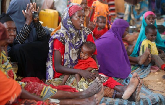 Internally displaced Somali women sit with their children inside their general shelter at the Al-cadaala camp in Somalia's capital Mogadishu